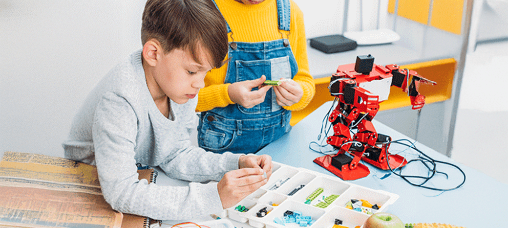 Students building and programming robots in hands-on after school robotics enrichment program