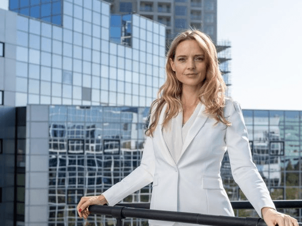 female similing while looking up at the clouds