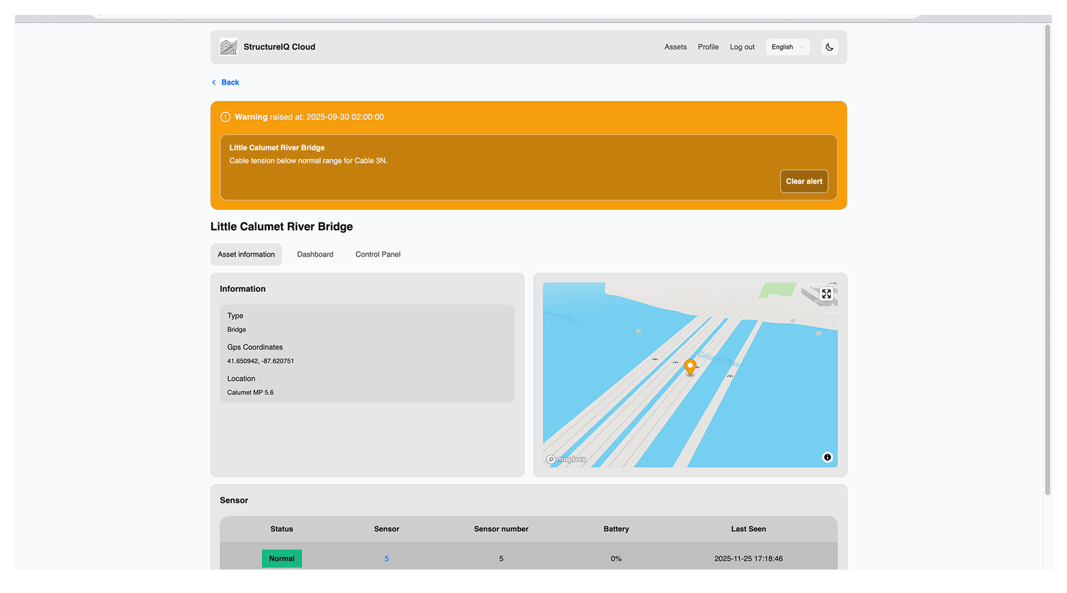 A large orange truck driving down a dirt road