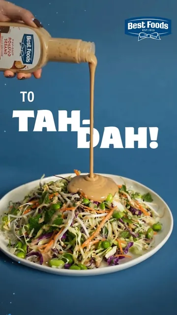 Sesame dressing pours over a noodle salad, under the words “To tah-dah!”