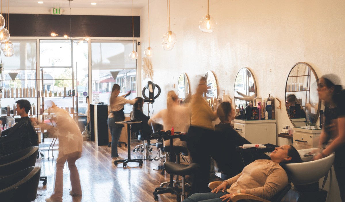 Stylists busy at work at Del Sol Hair Studio salon floor in Huntington Beach