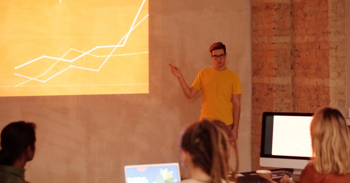 A young man gives a presentation on data analysis in a modern office setting.