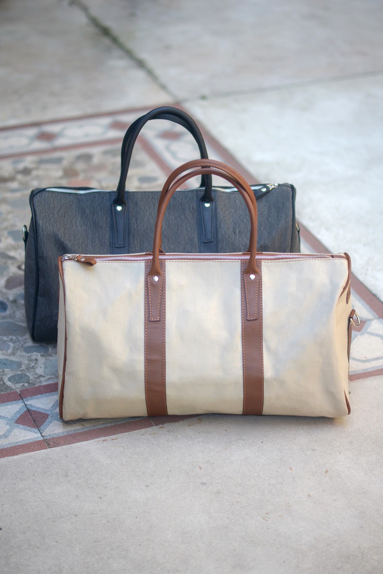 Close-up of a dark green leaf showing its textured surface and central vein against a muted background.