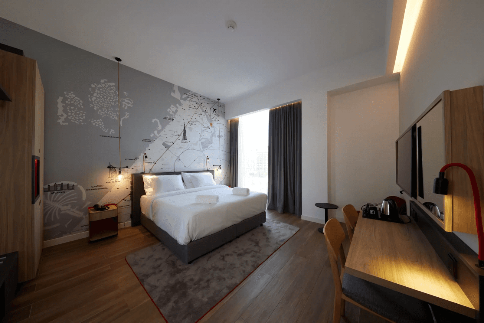 Pet-friendly hotel room at INK Hotel Dubai with a map-inspired feature wall.