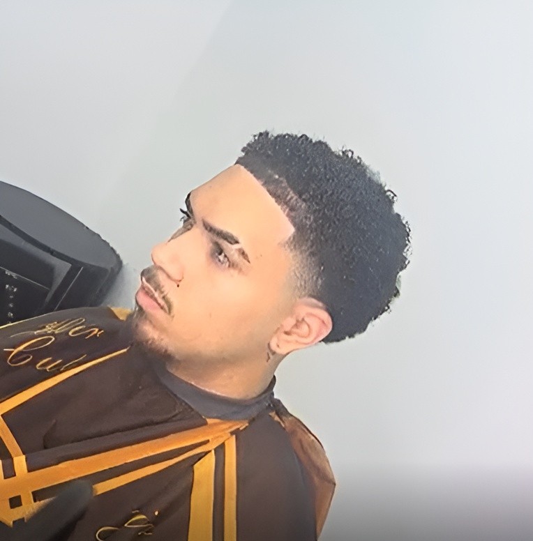 Clipper trimming the back of a man's hair