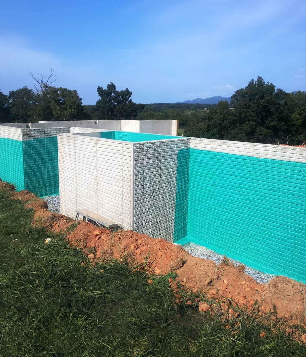 Photo of a building foundation coated in Rub-R-Wall waterproofing