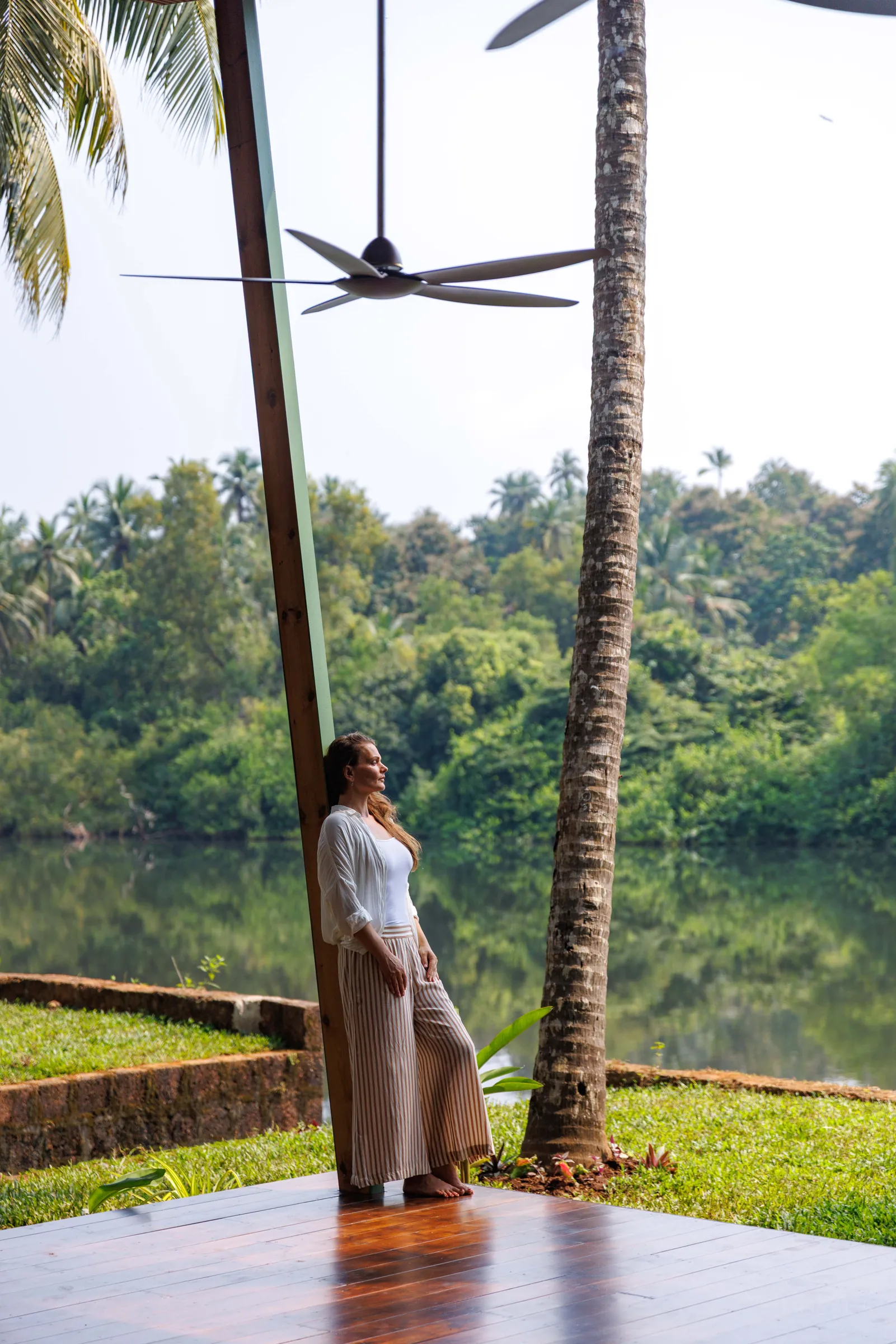 Guest leaning against a pavilion pillar beside the Talpona River