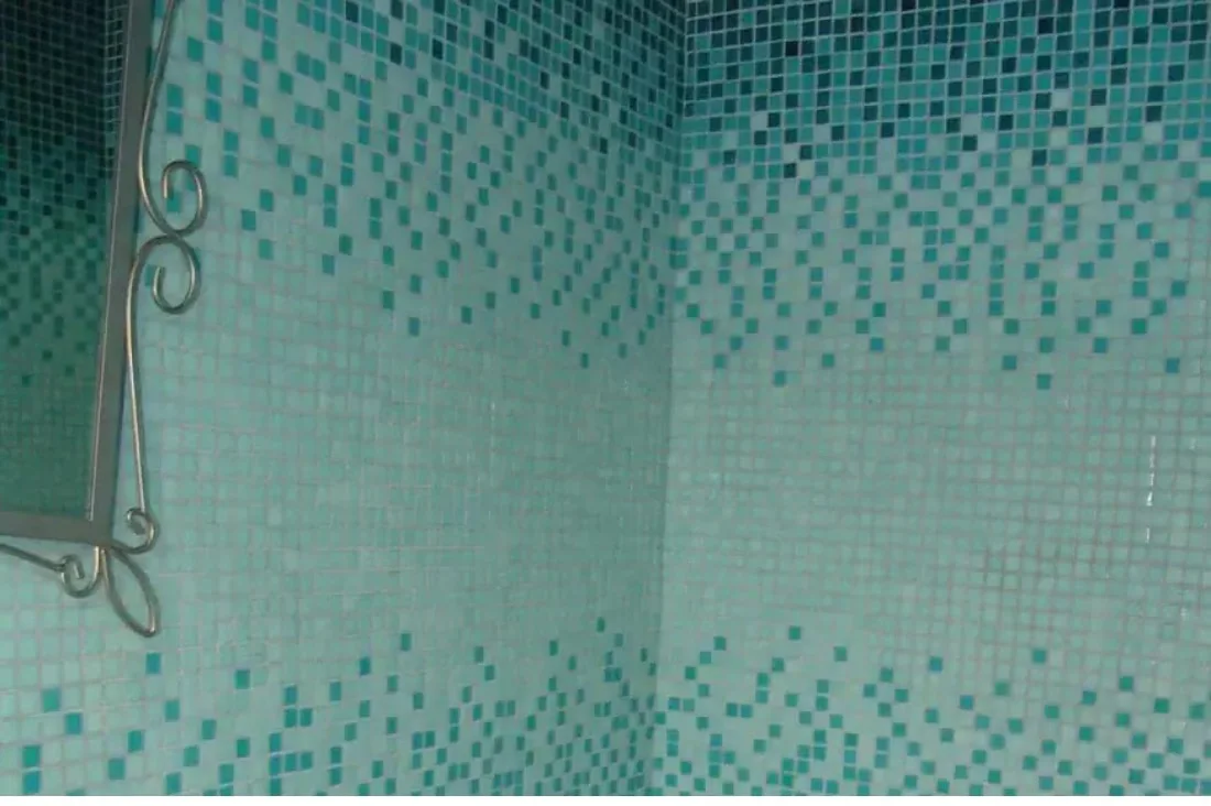 Wall finished in a teal glass gradient, dense at the top and thinning toward the bottom — Mosaiclegs Art Studio