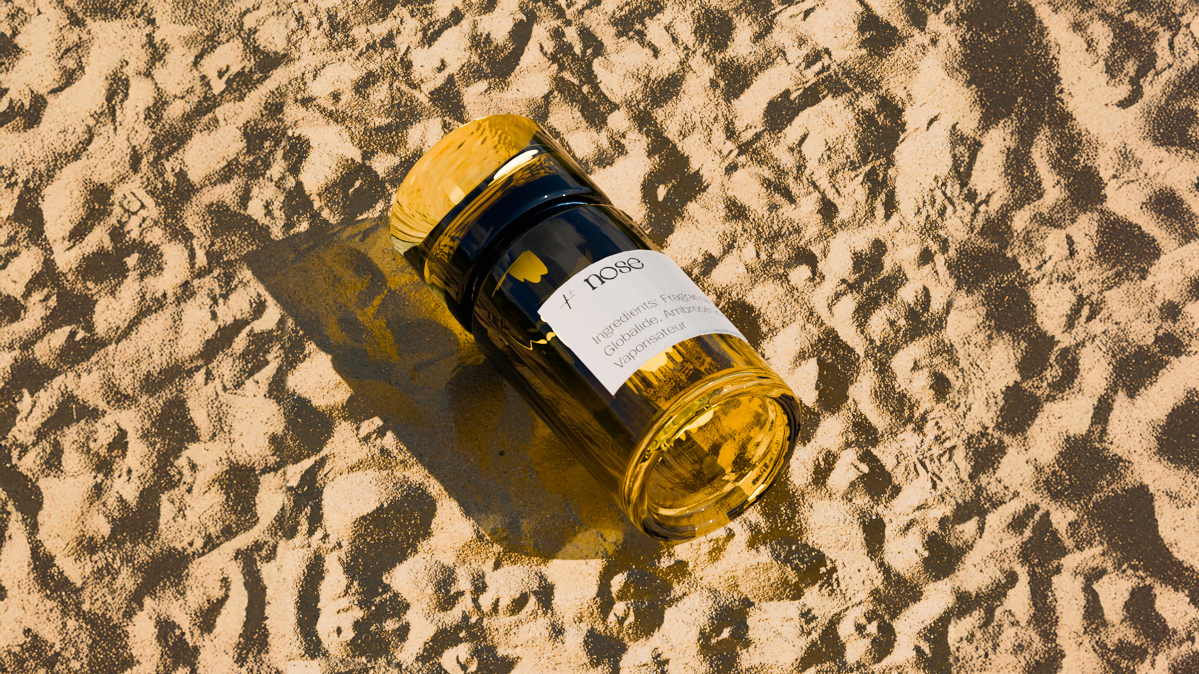 prefume bottle on some sand