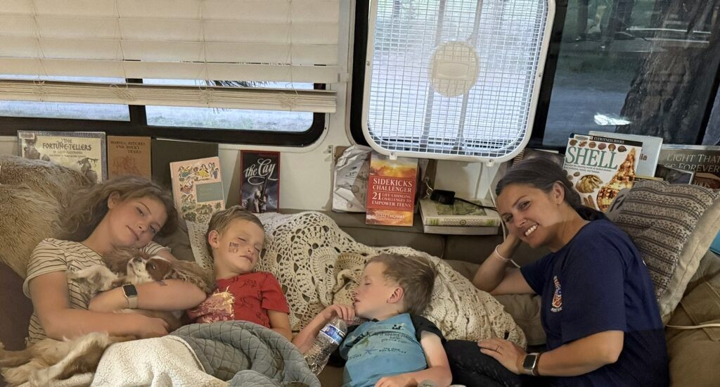 Family reading together on the RV couch in the evening