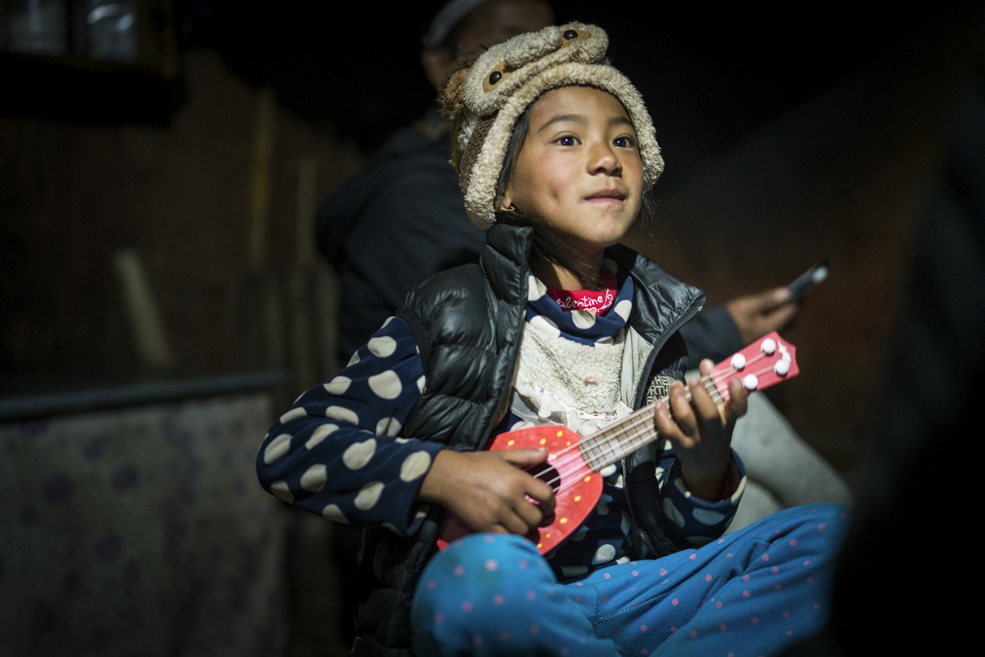 Girl playing toy guitar in the Himalaya