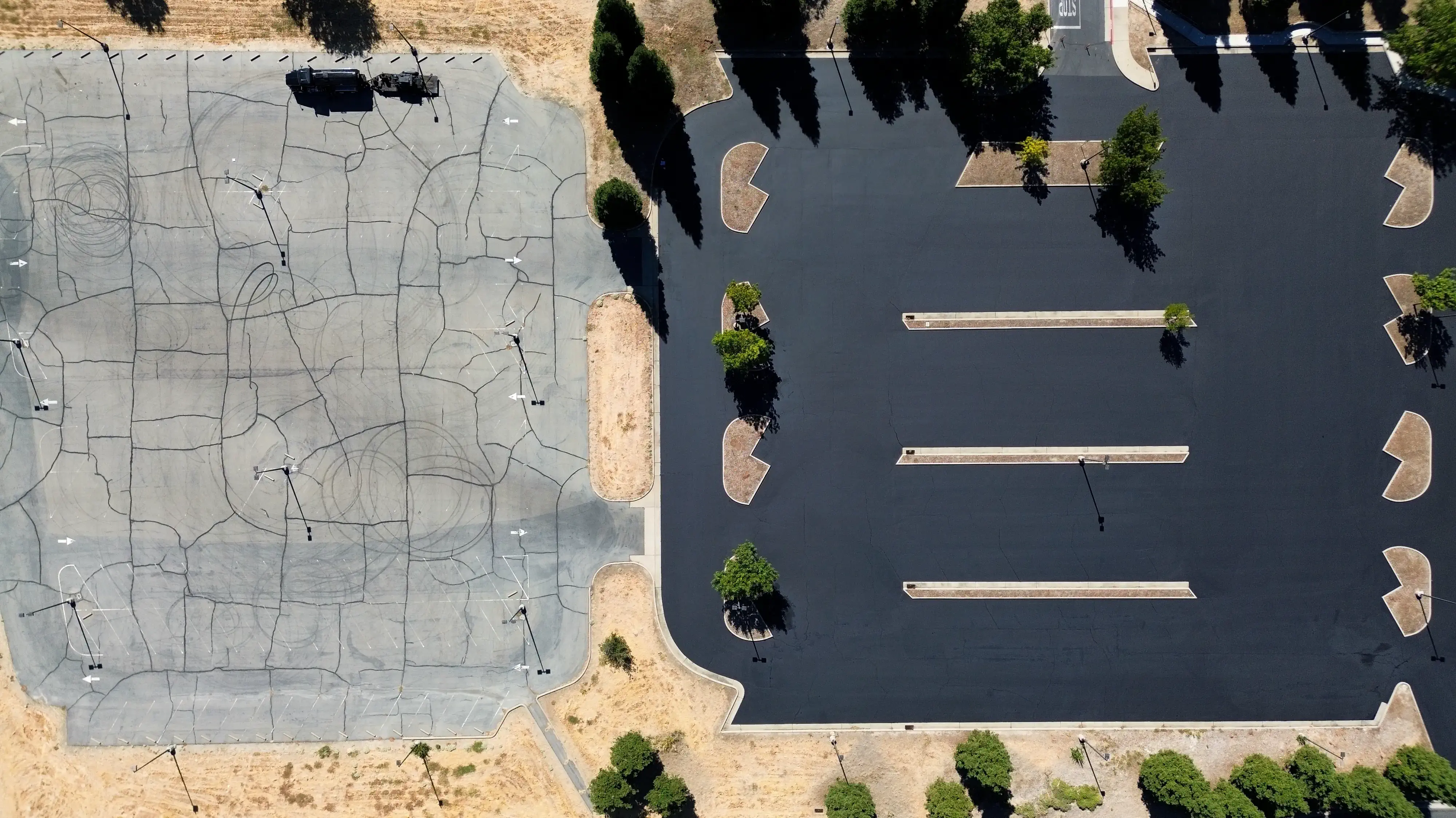 Adjacent parking lots showing weathered asphalt next to brand new pavement.