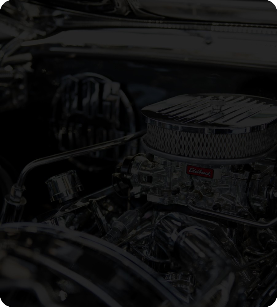 A detailed view of a mechanic repairing a European luxury car's engine.