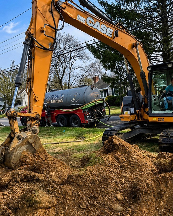 CASE excavator digging a trench with the tanker truck on site