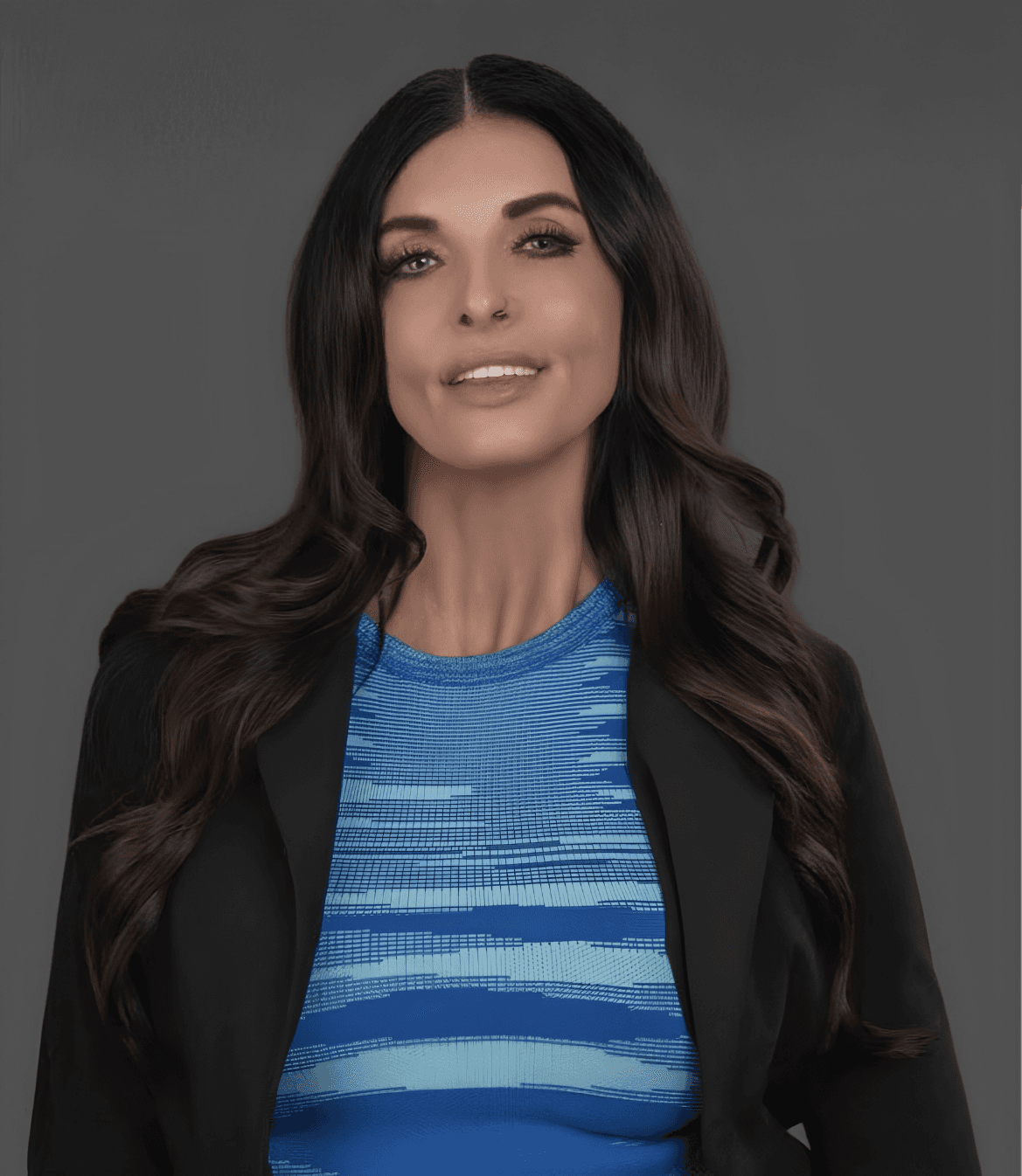 Professional headshot of Candice Noguera wearing a blue top and black blazer against a gray background.
