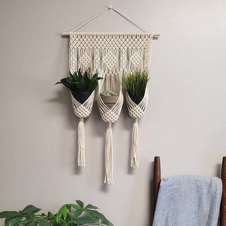Handcrafted macrame wall hanging with three plant holders