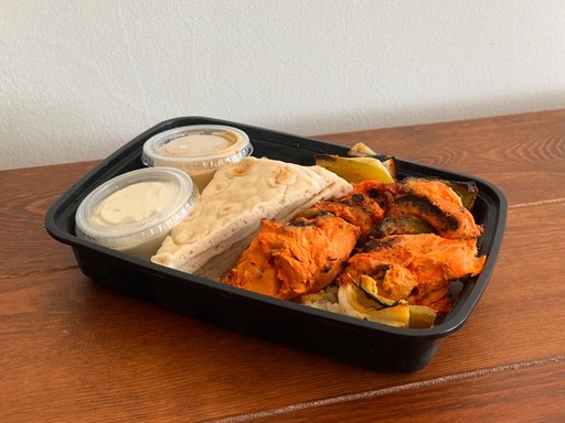 french toast breakfast, with bacon, maple syrup, eggs, and fruit