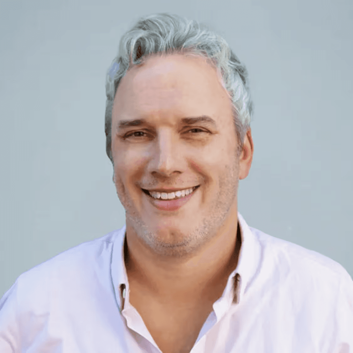 Black and white portrait of a smiling person with curly hair