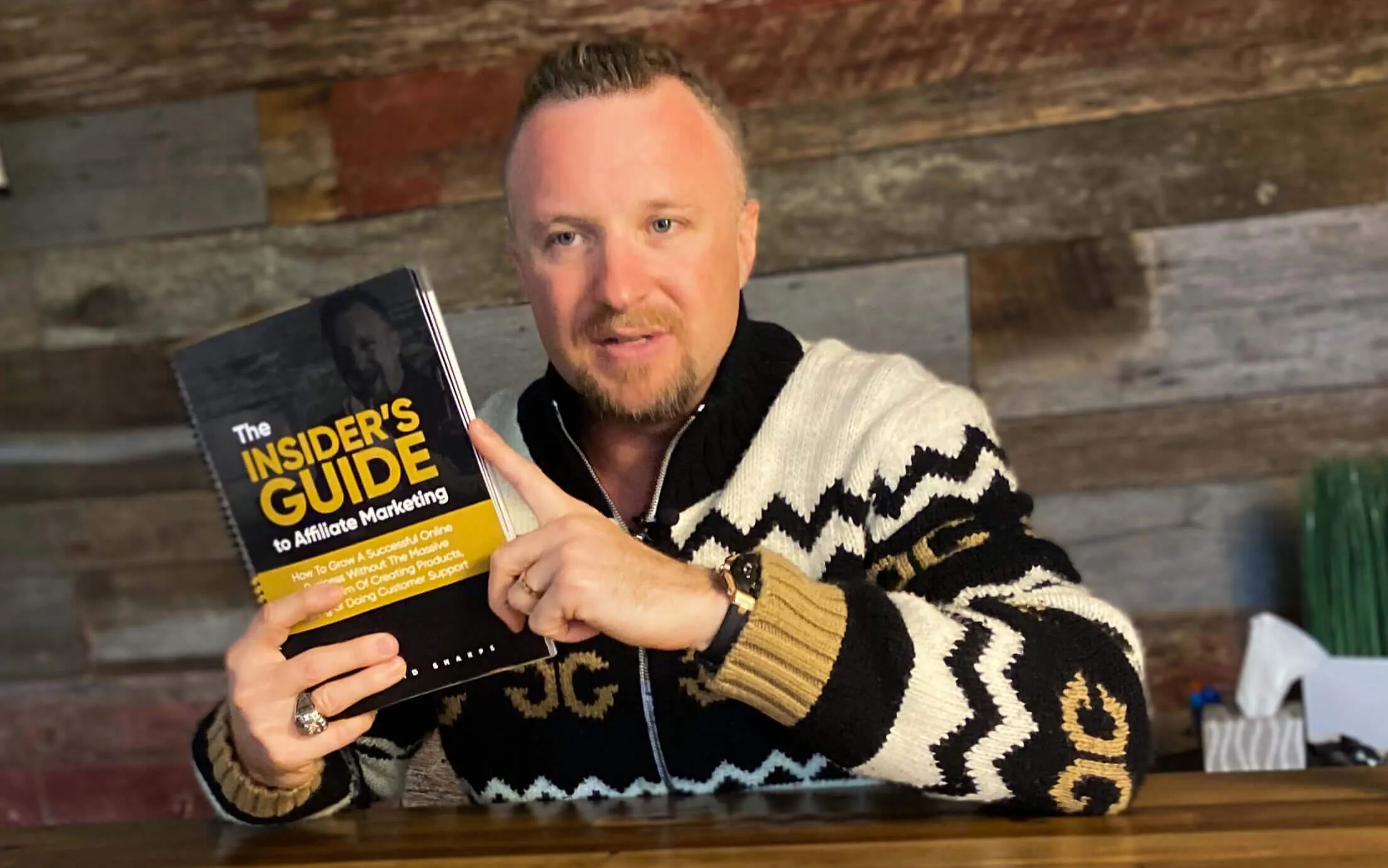 The founder David sharpe holding an affiliate marketing guide book on his hand