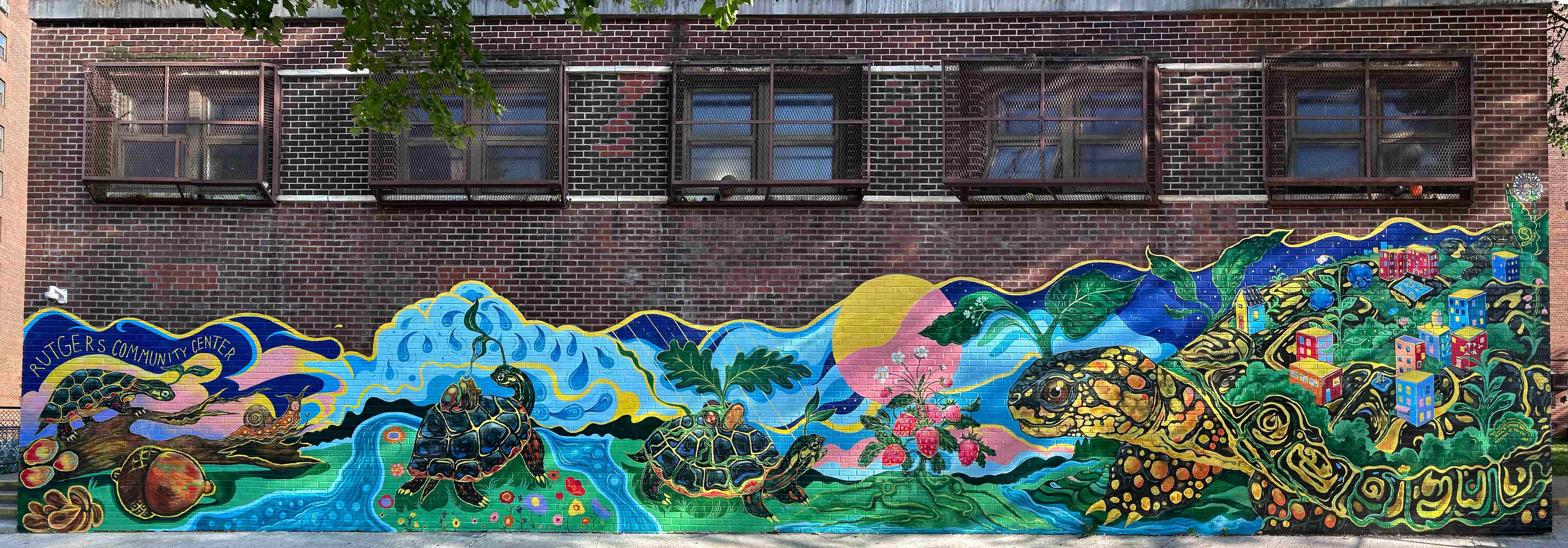 A vibrant mural about community and nature, featuring the myth of the world turtle.