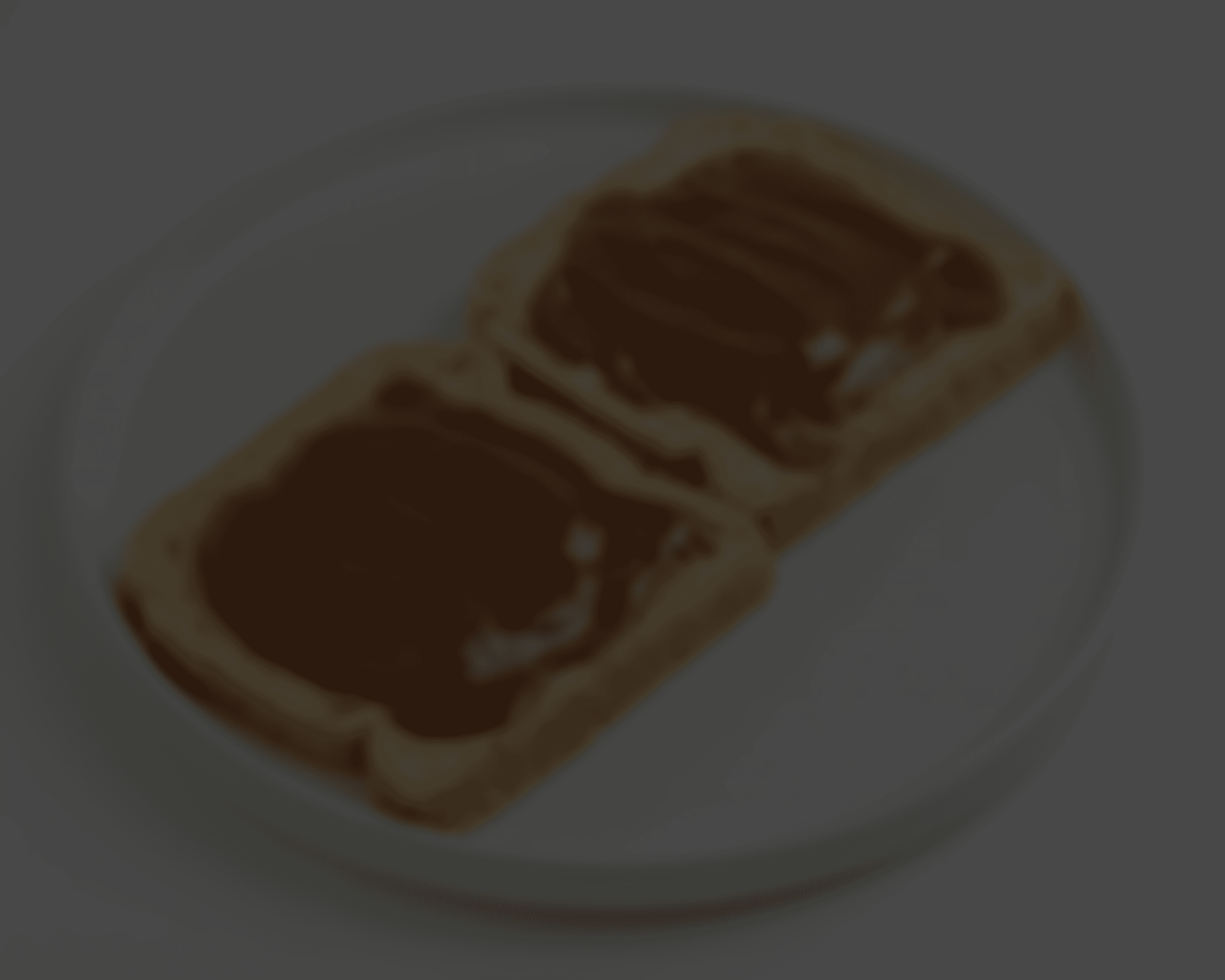 two pieces of bread with chocolate spread on them