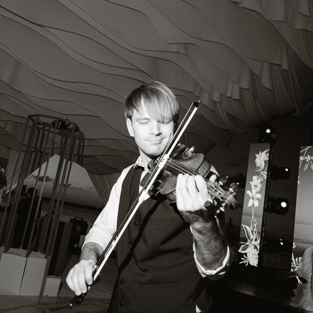 Black and white photograph of Kostia Lucky playing at a wedding reception