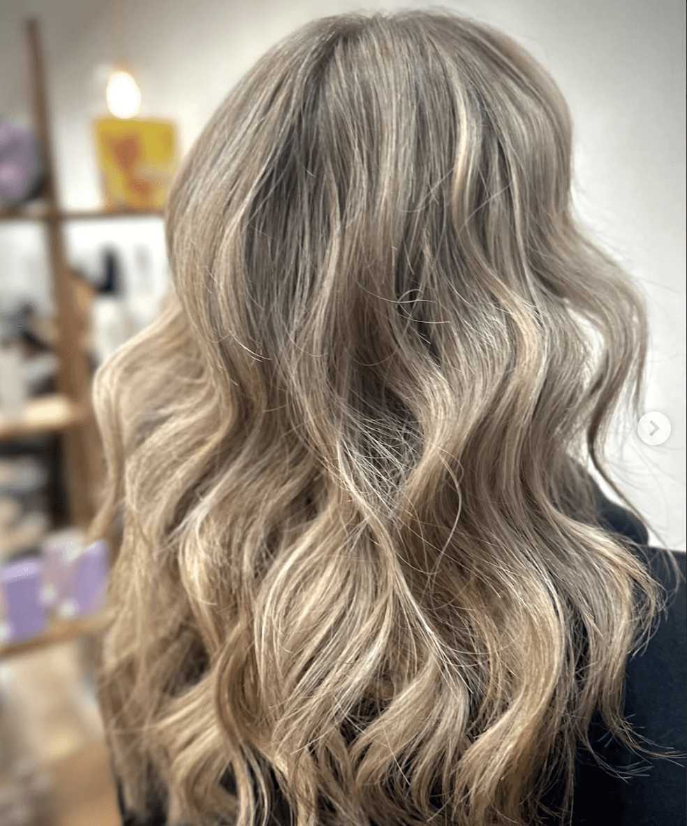 Soft lived-in dimensional blonde with natural waves by Marlie Allen at Del Sol Hair Studio Huntington Beach