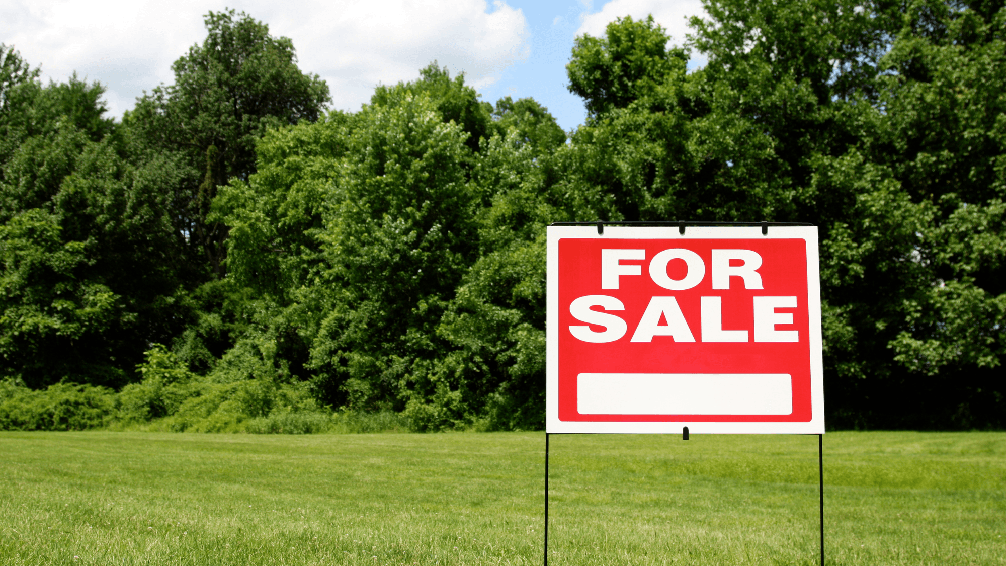Vacant land for sale sign representing agent, FSBO, and direct land sale options