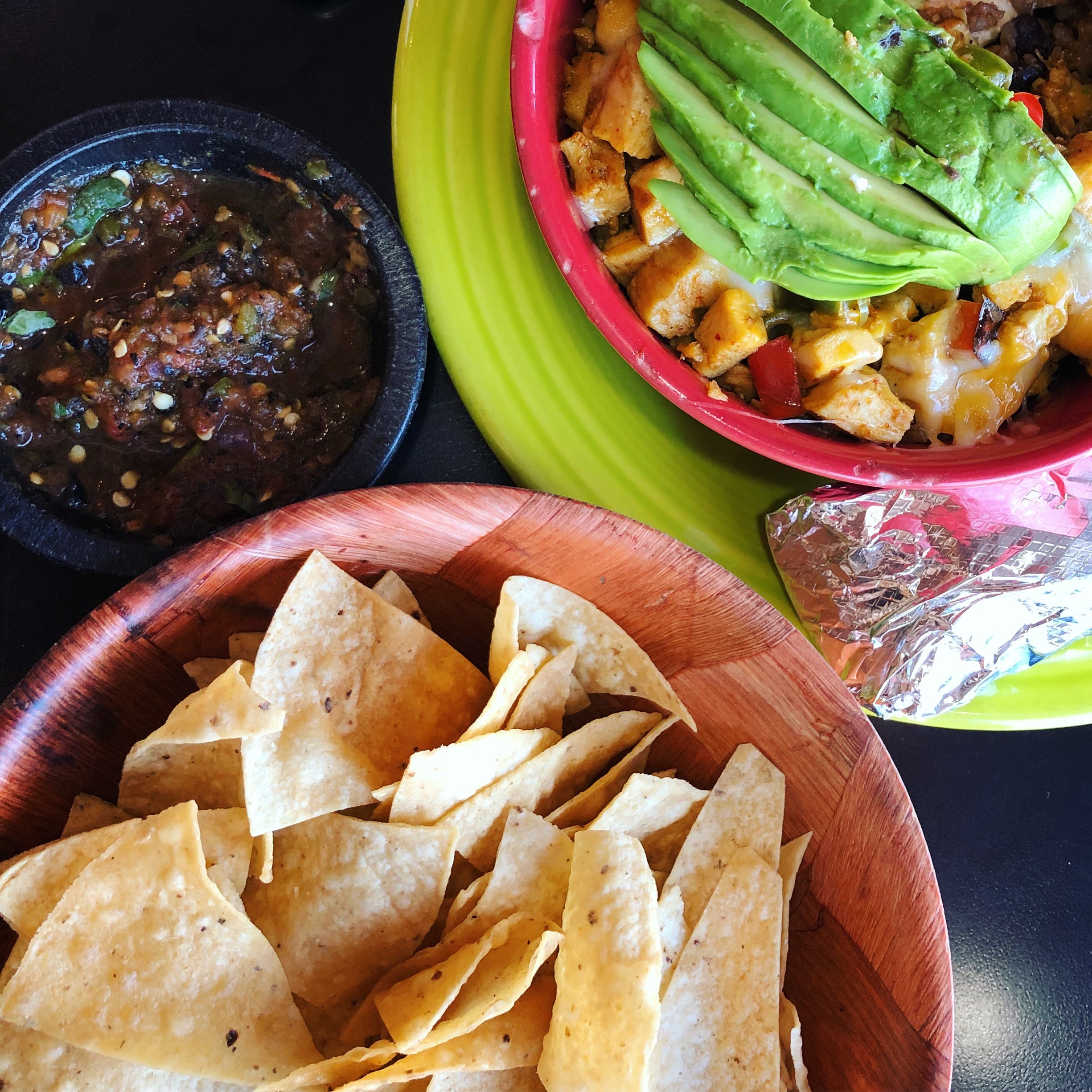 A vibrant plate of Enchiladas Mexicanas, featuring a mix of rojo, verde, and ranchero sauces with tender carne asada.