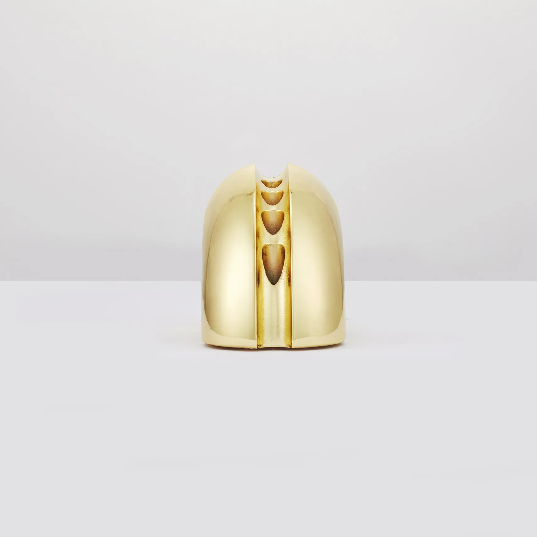 Polished gold Nosh Menorah form study shown upright on a light gray background