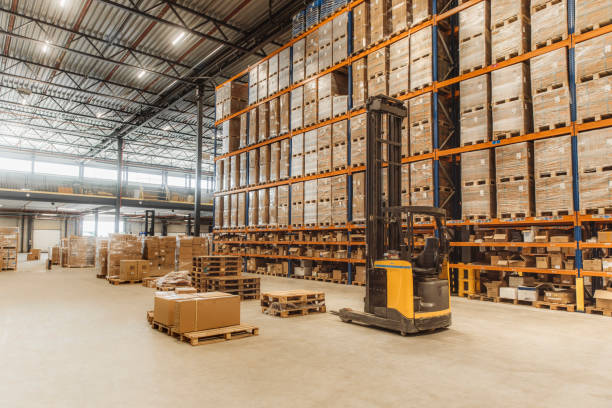 Image of a warehouse interior with forklifts and pallets