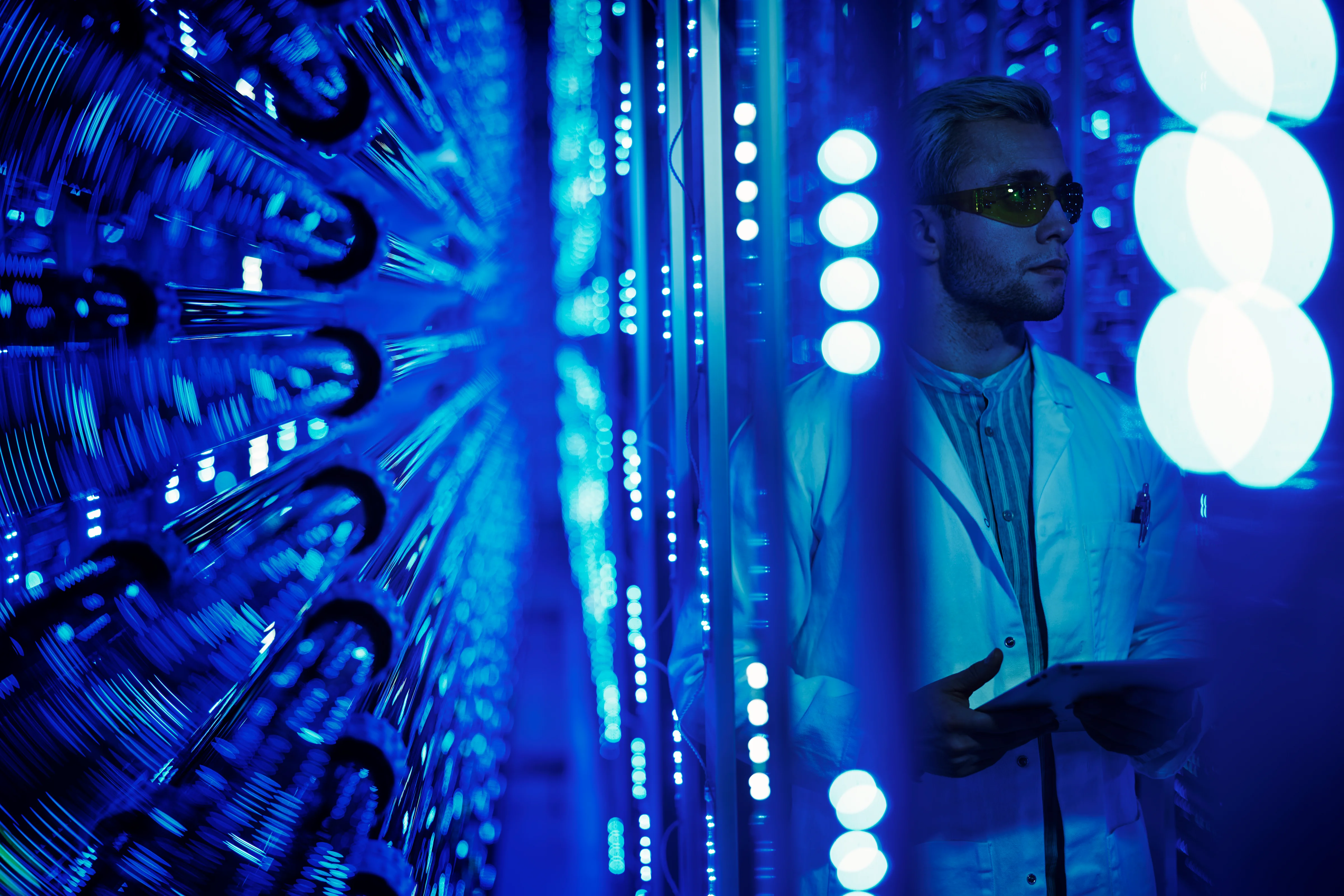 A researcher inside Algalíf’s algae cultivation facility in Iceland, monitoring illuminated growth tubes used for sustainable biotech production.