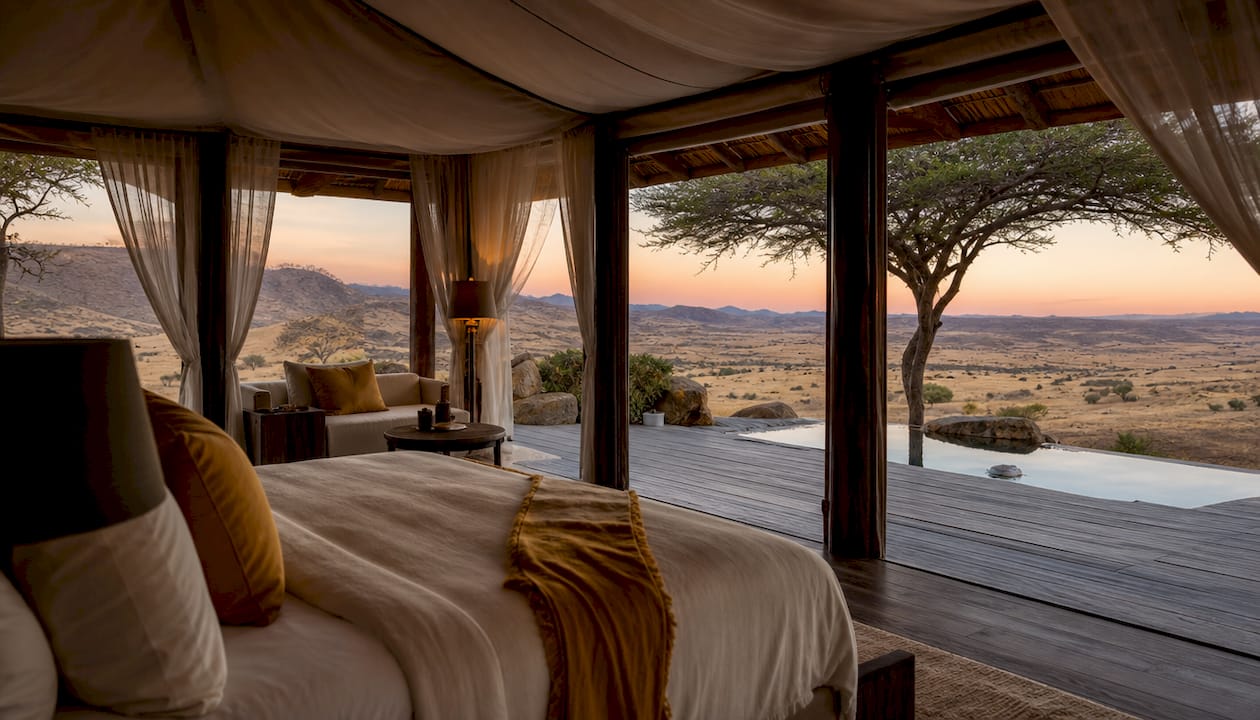 Elegant safari tent suite interior with plunge pool, desert view