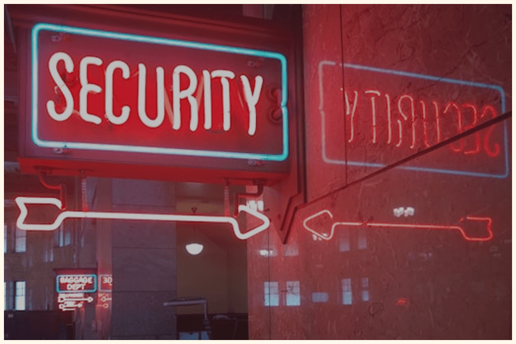 Red neon “SECURITY” sign with arrow and reflection