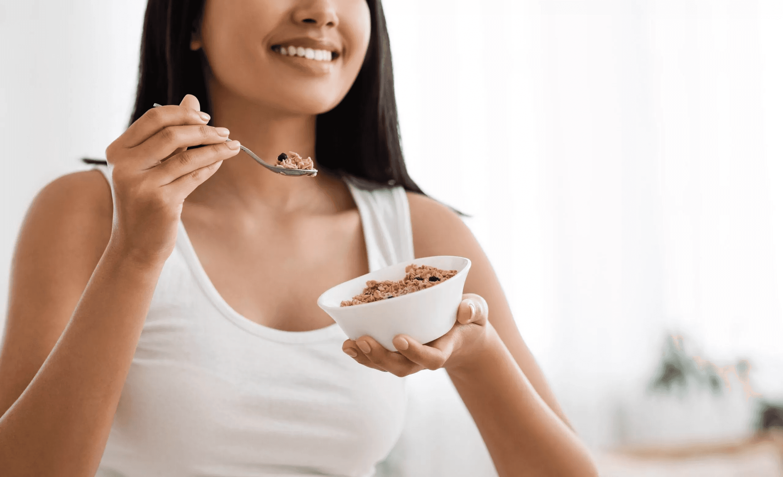 Woman eating a healthy breakfast - How Much Protein Should I Eat on Semaglutide