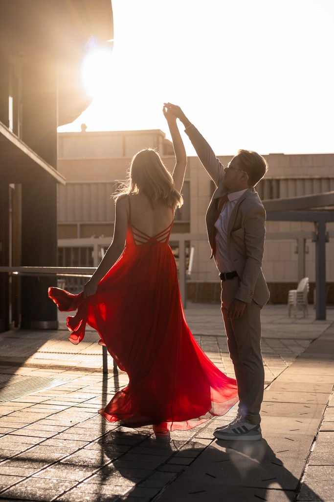Portrait of friends dancing under golden light