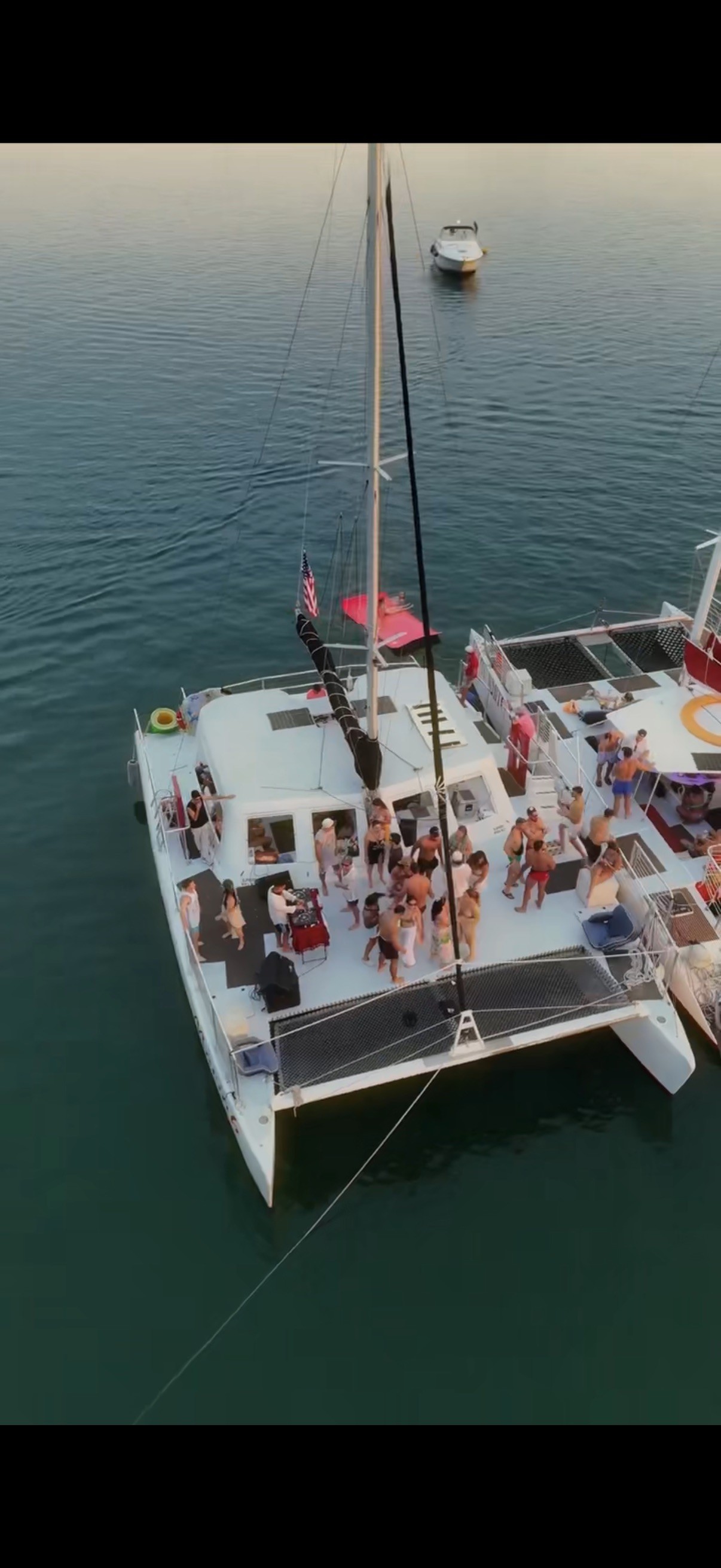 man standing near cliff looking at body of water during daytime