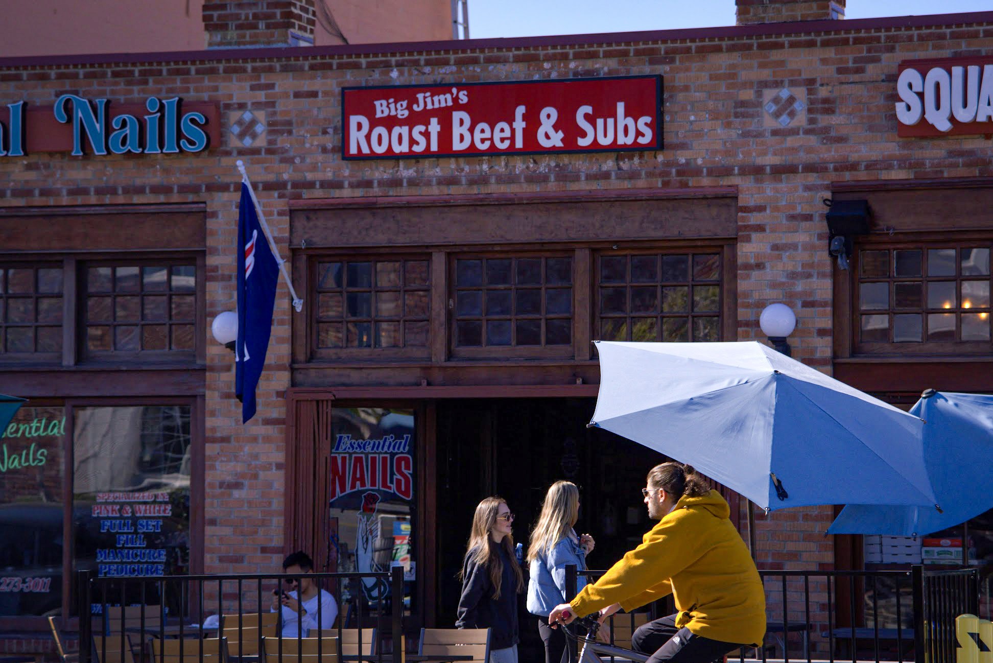 The outside exterior of Big Jim's Roast Beef with locals enjoying the best sandwiches and subs in Pacific Beach, San Diego