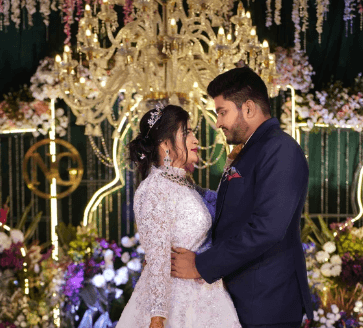 Mountain refuge illuminated at night under starry sky.