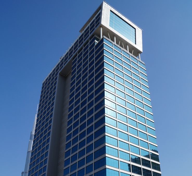 Sleek glass exterior of Clover Bay Tower, highlighting prime Business Bay real estate opportunities.