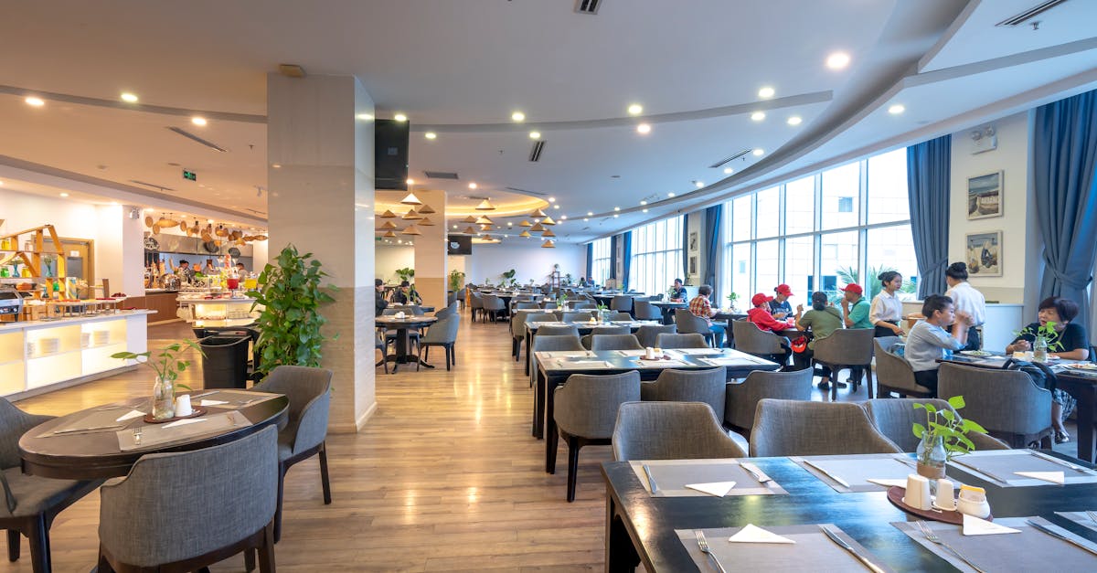 Spacious restaurant interior with guests dining and modern decor.