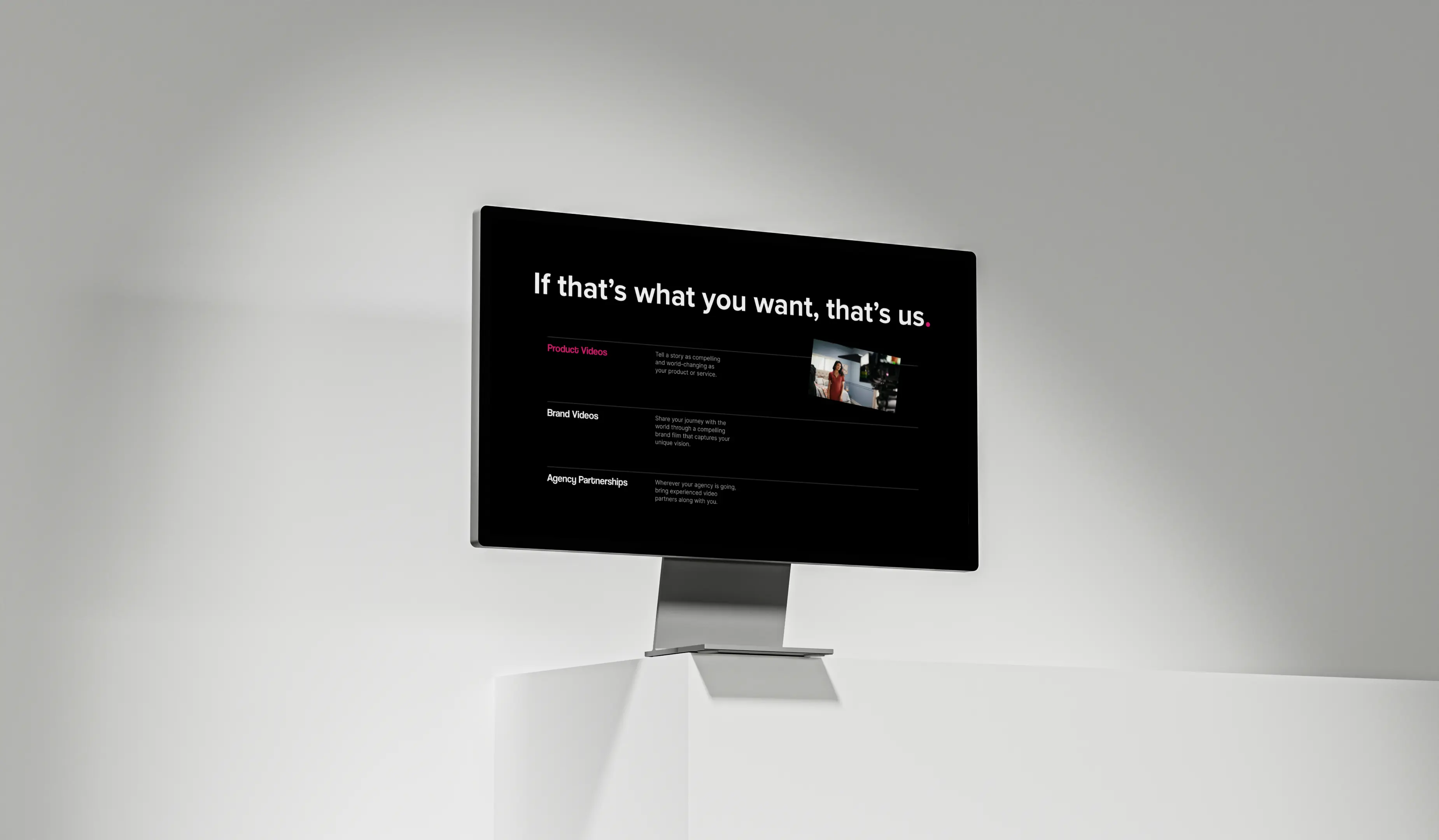 A black monitor displaying a digital interface, mounted on a wall with a simple design.