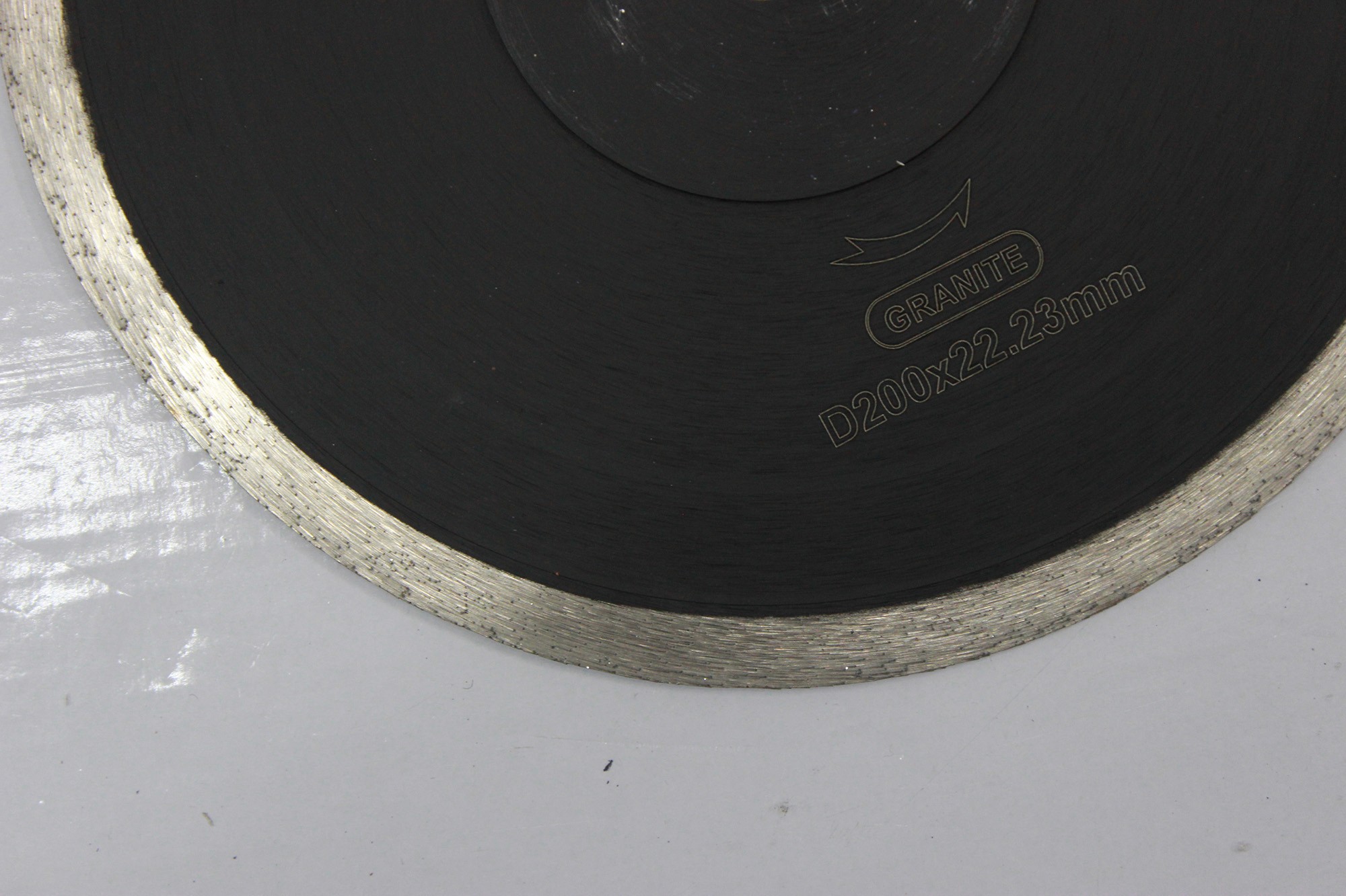 Close-up of the size marking on a sintered continuous rim blade, focusing on the details.