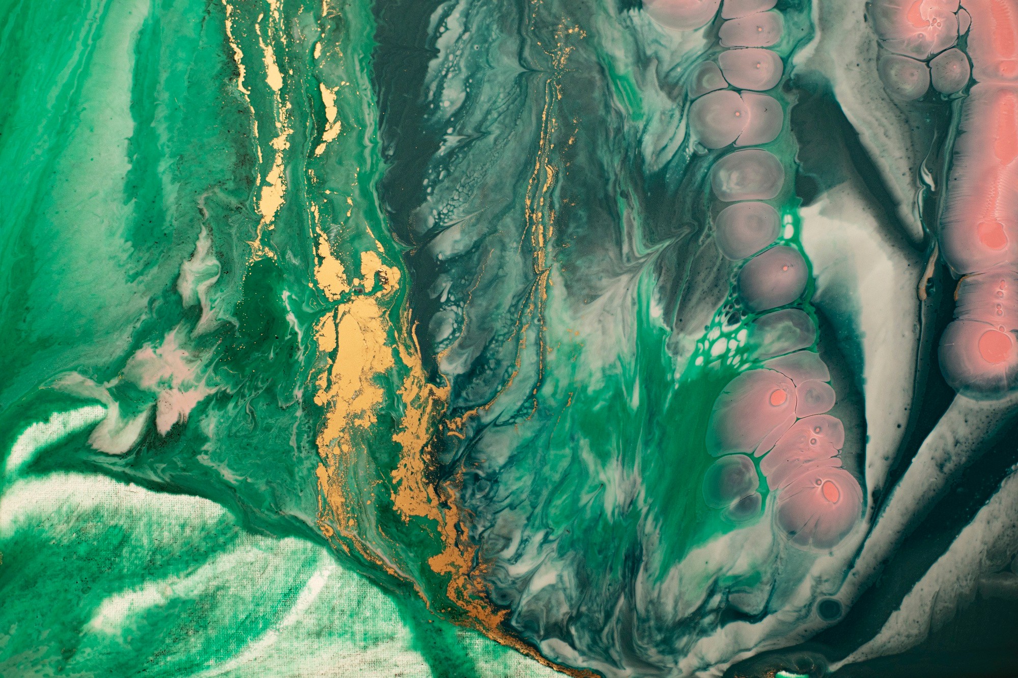 Close-up of a marble featuring green, pink, and yellow swirls.