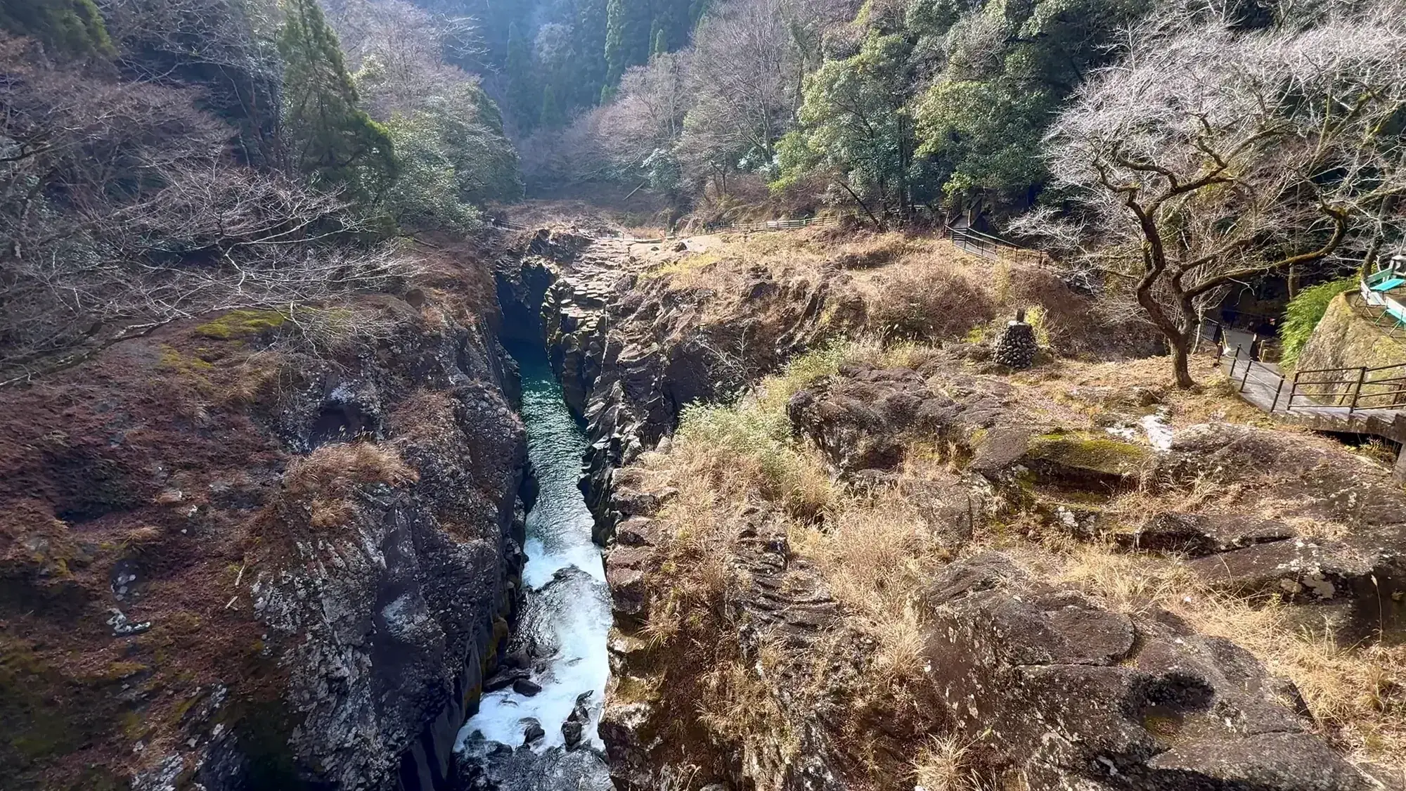 Aerial view of a narrow gorge cutting through scrub near Kurokawa Onsen