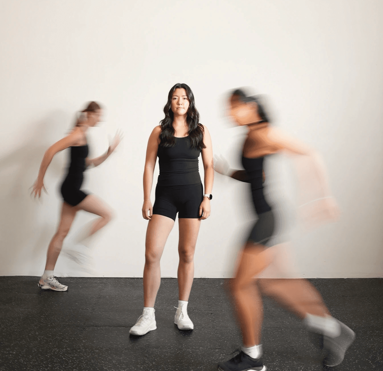 Woman holding a dumbbell behind her back