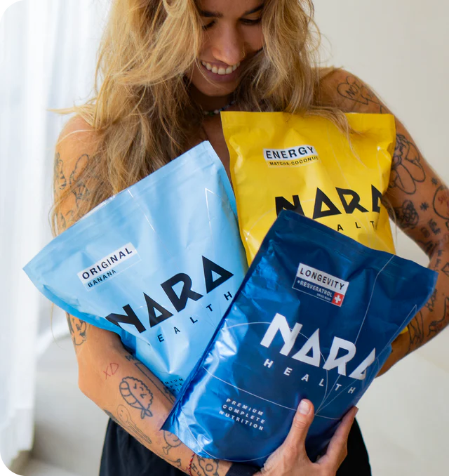 Smiling woman holding colorful Nara nutrition product packages.