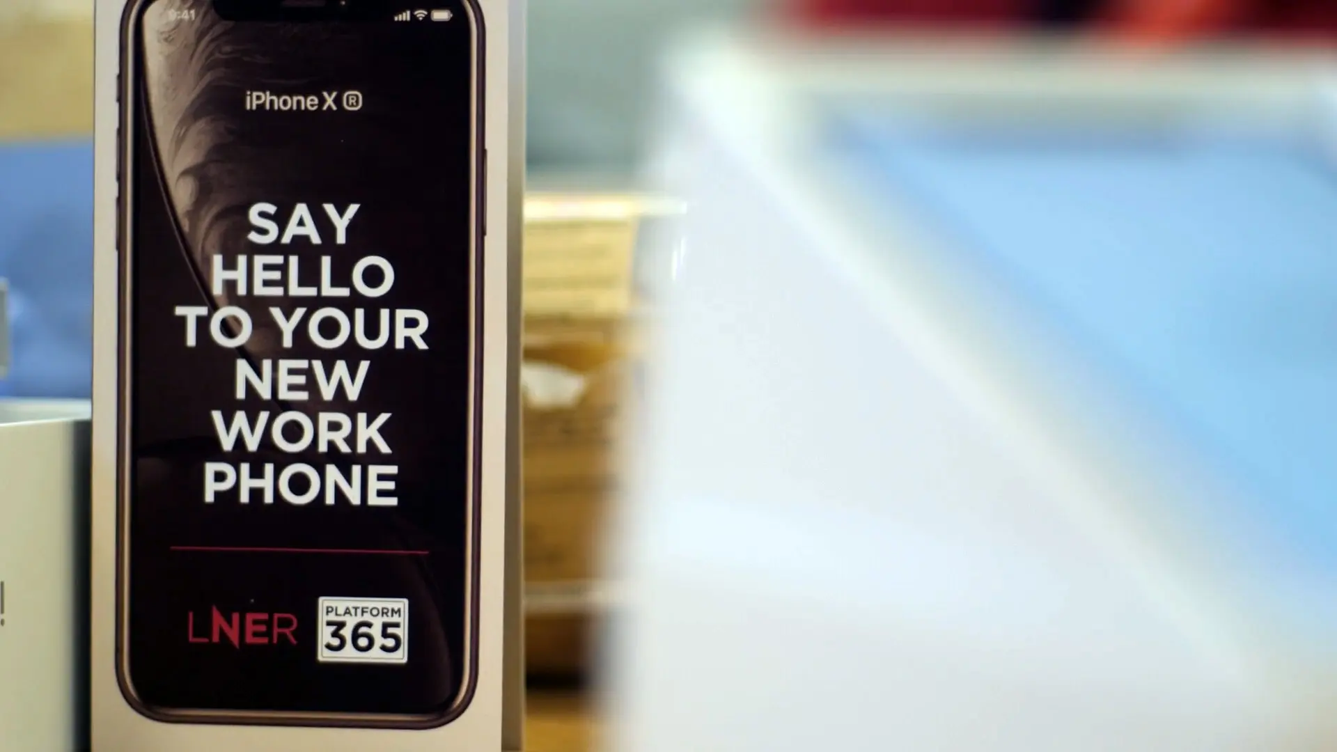 Iphone display reading "Say hello to your new work phone" as part of LNER Platform 365 rollout.