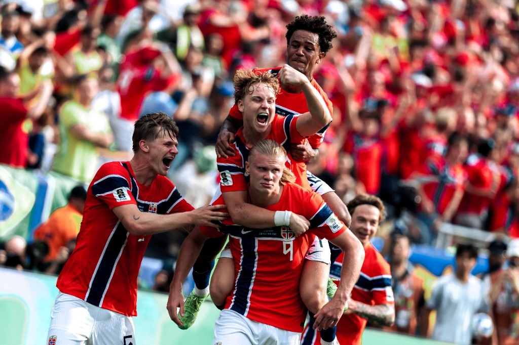 Erling Haaland carries a teammate on his back as Norway celebrate a goal against Brazil in the World Cup Round of 16
