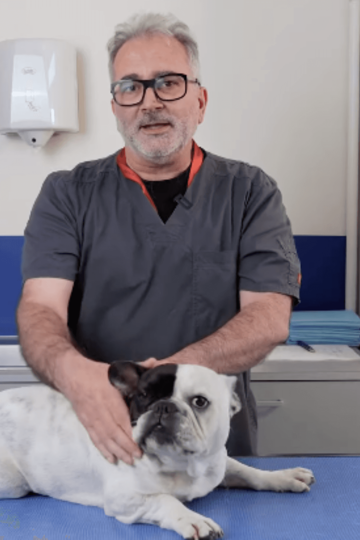 Young man in a formal outfit with a striped shirt, grey tie, and black coat. The tone is serious and professional, emphasizing subdued elegance.